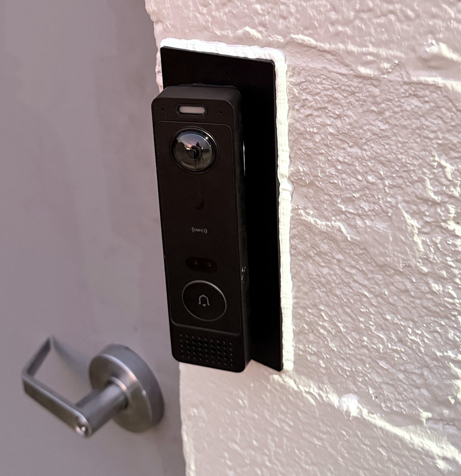 Video doorbell beside a commercial door